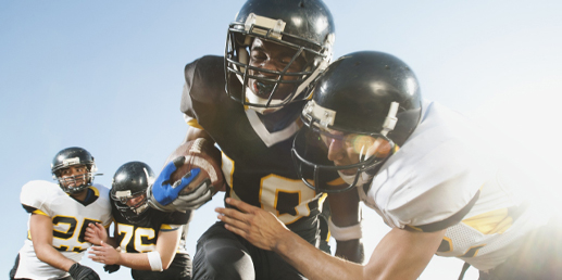 Photo of a doctor examining an athlete's knee