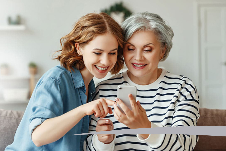 older mother and daughter using smart phone